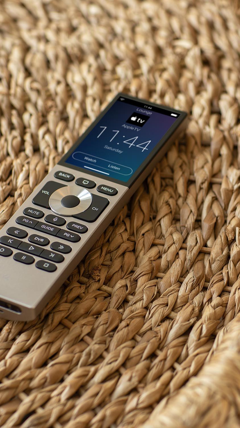 Smart remote control resting on woven natural fiber surface