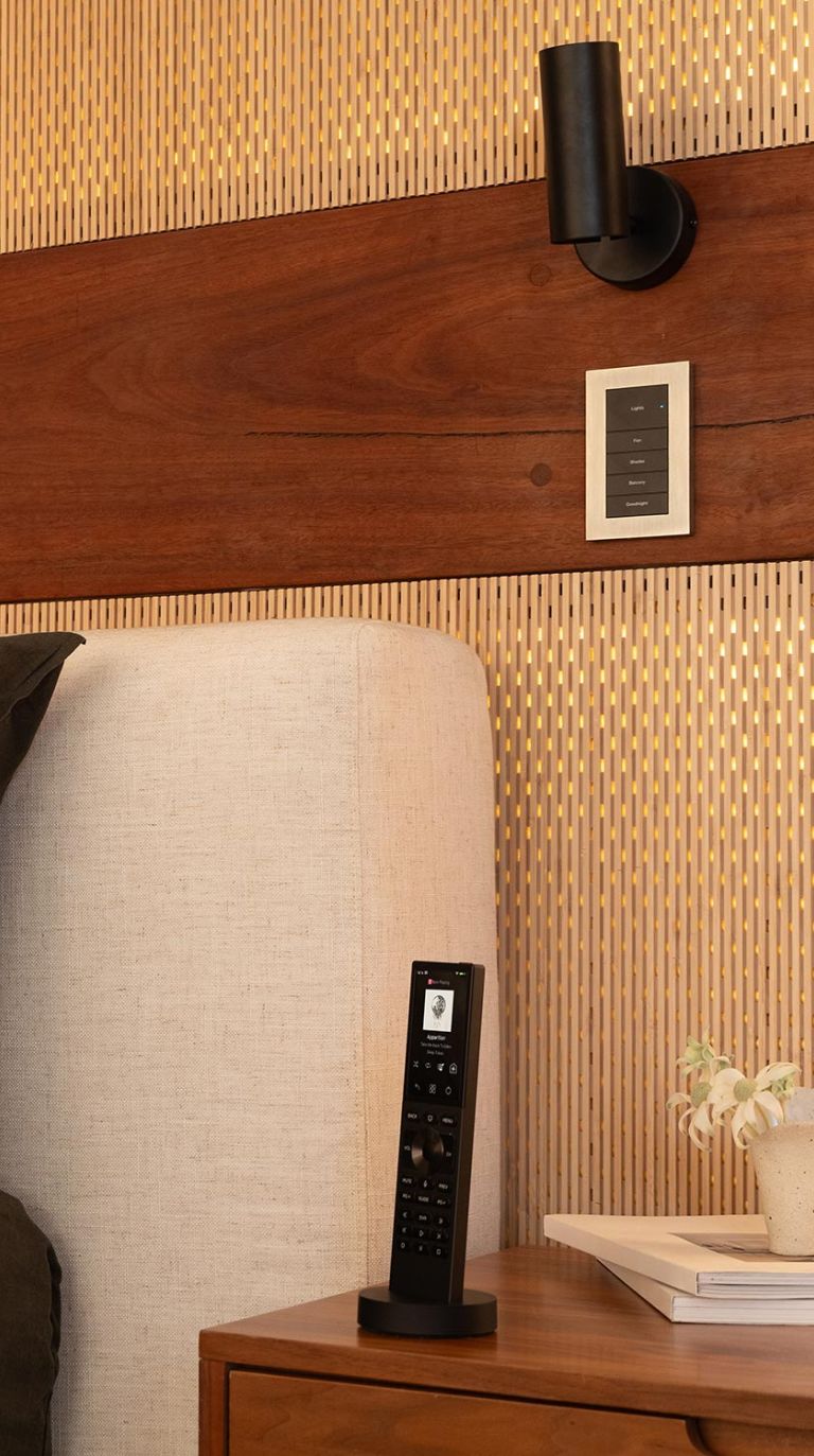 Bedroom with light control panel and smart remote on nightstand