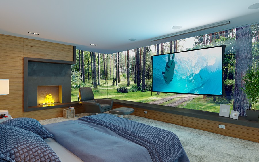  A bedroom with a fireplace, in-ceiling speakers, an SI-Zero-G screen, and picture windows looking out on a forest. 