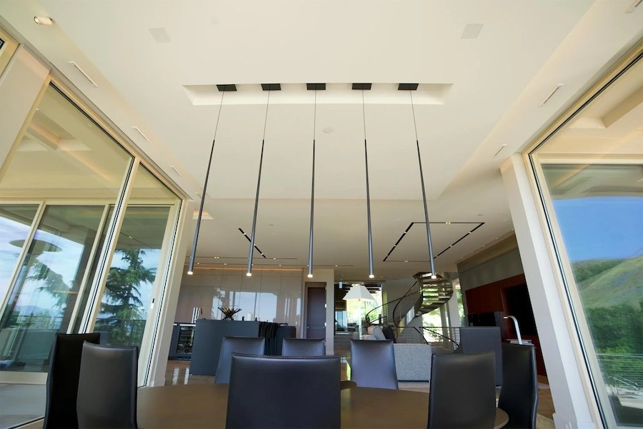 contemporary pendant lighting fixtures above a dining room table.