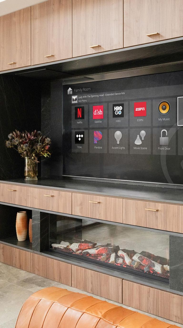 Built-in entertainment system with streaming apps on screen and modern fireplace below