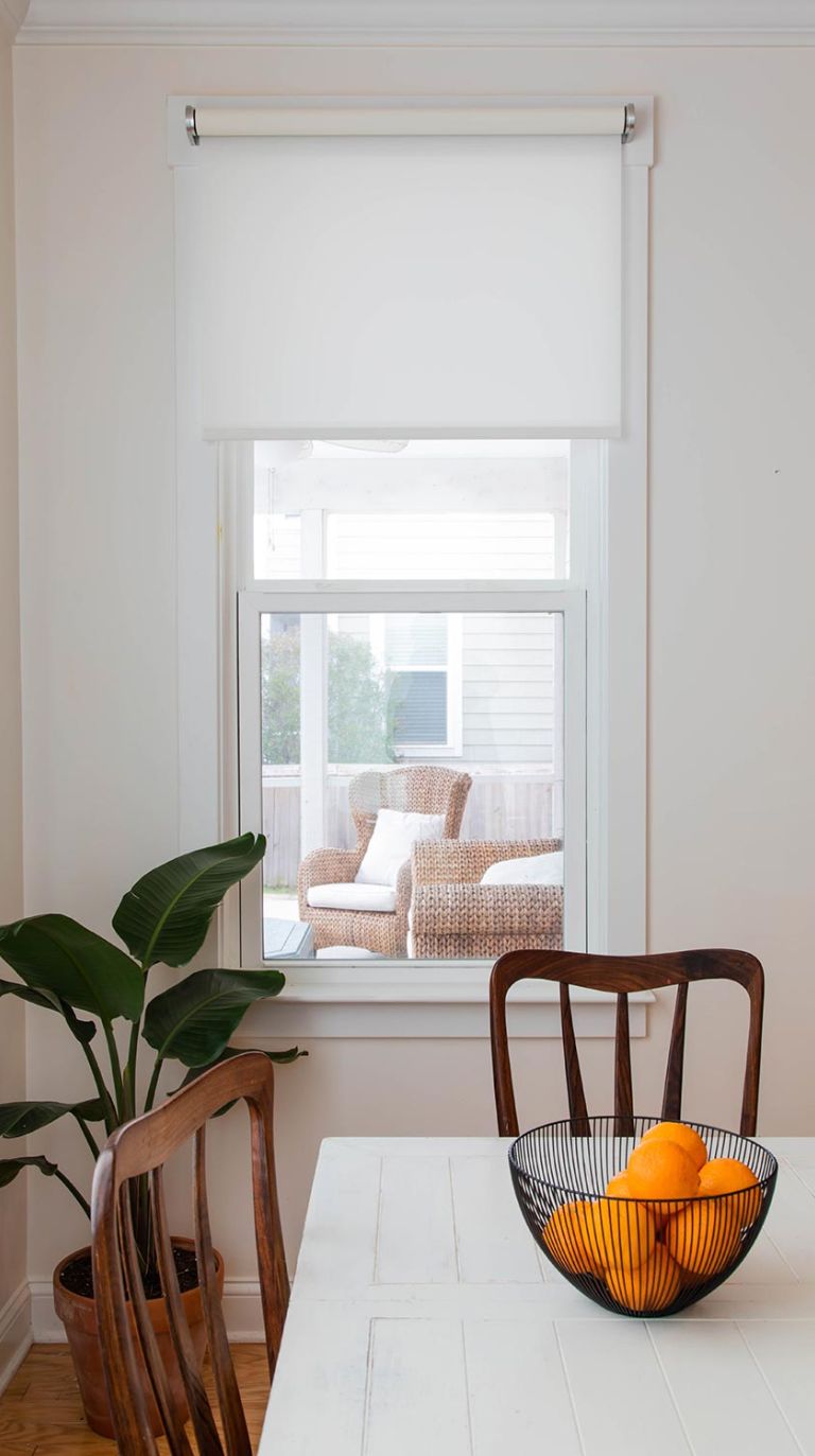 Dining area with automated window shade and natural light